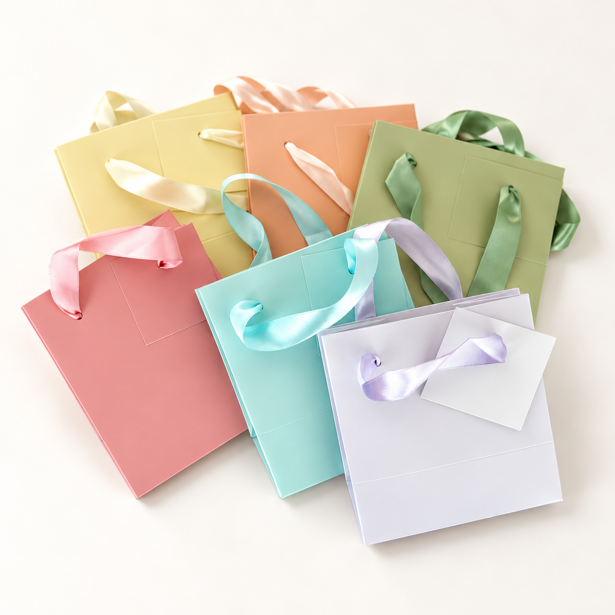 Assorted pastel gift bags: yellow, peach, sage, pink, aqua and lavender