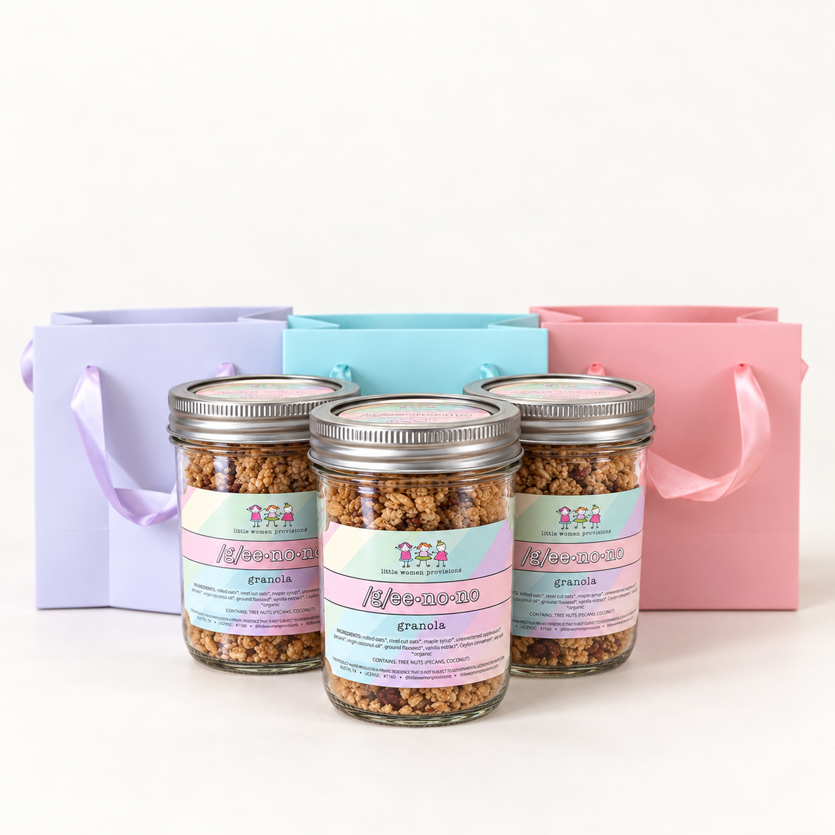 Geenono mini trio: three 8oz jars in front of lavender, aqua and pink gift bags